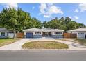 Inviting single-story home with blue accents, a private garage, and a spacious driveway at 5826 20Th S Ave, Gulfport, FL 33707