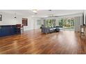 Spacious living room with hardwood floors, a bar, and sliding glass doors to the backyard at 5826 20Th S Ave, Gulfport, FL 33707