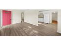 Open-concept living room with wood-look floors flowing into the kitchen area at 601 Newton S Ave, St Petersburg, FL 33701