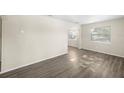 Bright living room with two windows and wood-look floors at 601 Newton S Ave, St Petersburg, FL 33701