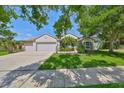 Charming single-story home featuring well-maintained lawn, mature trees, and a three-car garage at 6107 Heroncrest Ct, Lithia, FL 33547