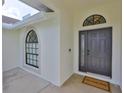 Inviting front entrance with an arched window, modern black door, and a 'welcome home' doormat at 6332 35Th Avenue E Cir, Palmetto, FL 34221