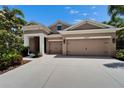 A gorgeous one story home showcasing a three car garage and beautiful landscaping at 6507 Maiden Sea Dr, Apollo Beach, FL 33572