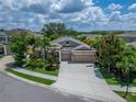 A beautiful one-story home showcasing a three car garage, well manicured landscaping, and situated in a wonderful neighborhood at 6507 Maiden Sea Dr, Apollo Beach, FL 33572