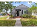 Quaint home with neutral siding, black shutters and a welcoming front entrance at 720 39Th N Ave, St Petersburg, FL 33703