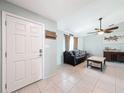 Bright living room featuring tile floors, a ceiling fan, and a comfortable seating area at 7237 Bramblewood Dr, Port Richey, FL 34668