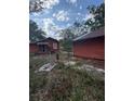 Exterior of the detached garage and back of home in the backyard at 7807 N Mulberry St, Tampa, FL 33604