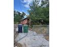 Exterior view of red house and gate with trash cans visible at 7807 N Mulberry St, Tampa, FL 33604