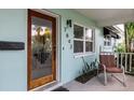 Inviting front porch with seating, showcasing the entrance and natural light from the windows at 7842 15Th N Way, St Petersburg, FL 33702