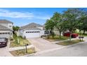 Beautiful single-story home featuring a brick driveway, two-car garage, and lush landscaping at 8407 Hunters Fork Loop, Ruskin, FL 33573