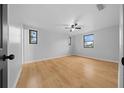Bright, spacious bedroom featuring new hardwood flooring, fresh paint and modern ceiling fan at 9613 River Rd, Spring Hill, FL 34608