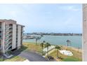 Waterfront view from a high-rise condo, featuring shuffleboard courts, marina, and Gulf at 1 Key Capri # 502E, Treasure Island, FL 33706