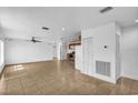 Open concept featuring tile flooring, recessed lighting, ceiling fan, and spacious living area at 10701 Village Green Ave, Seminole, FL 33772