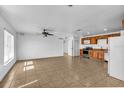 Bright living room featuring an open floor plan, tile floors, and a ceiling fan at 10701 Village Green Ave, Seminole, FL 33772