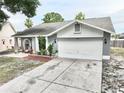 Charming single-story home with a well-manicured lawn, a two-car garage, and a welcoming front porch area at 11314 Silverleaf Ct, Riverview, FL 33579