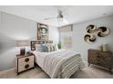 Comfortable bedroom with a ceiling fan, decorative wall art, and a cozy bed with stylish bedside tables at 119 Leisure Pl, Rotonda West, FL 33947
