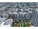 An aerial view of a dense urban area with condos, commercial buildings, parks, and waterways under a cloudy sky at 1208 E Kennedy Blvd # 914, Tampa, FL 33602