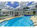 Backyard screened in pool with blue tile and covered in ground spa at 1829 1St E Ave, Bradenton, FL 34208