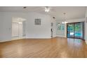 Bright living room with wood floors and sliding glass doors leading to the pool at 18546 Kelly Rd, Spring Hill, FL 34610