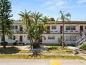 A two-story condo building with a well-manicured lawn and tropical landscaping at 1900 58Th N Ave # 26, St Petersburg, FL 33714