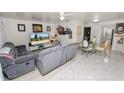 Bright living room features neutral colors, updated flooring, ceiling fan and furniture at 1900 58Th N Ave # 26, St Petersburg, FL 33714