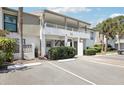 Inviting exterior of the condo building, featuring a spacious covered balcony, parking, and well-maintained landscaping at 1981 Lakewood Club S Dr # 4M, St Petersburg, FL 33712