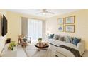 Comfortable living room with neutral walls, tiled floor, and a sliding glass door that fills the space with natural light at 1981 Lakewood Club S Dr # 4M, St Petersburg, FL 33712