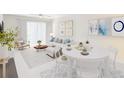 Bright and airy living room and dining area featuring stylish decor, neutral colors, tile floors, and modern furniture at 1981 Lakewood Club S Dr # 4M, St Petersburg, FL 33712