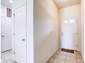 View of the entryway with tiled floors and a white front door with glass panels at 1984 Hawks View Dr, Ruskin, FL 33570
