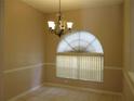 Dining room featuring neutral walls, tiled floors, and a chandelier at 2213 Towering Oaks Cir, Seffner, FL 33584