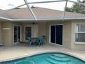 Covered patio area overlooking the pool, perfect for outdoor dining and entertaining at 2213 Towering Oaks Cir, Seffner, FL 33584
