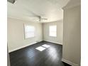 Bright bedroom with hardwood floors, white trim, and dual windows providing natural light at 3412 N 54Th St, Tampa, FL 33619