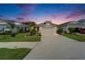 Charming single-Gathering home featuring a well-manicured lawn, landscaped garden beds, and a two-car garage at 3603 Woodmont Dr, Parrish, FL 34219
