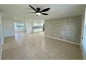 Spacious living area with tile flooring and a modern ceiling fan at 4322 Baden Dr, Holiday, FL 34691