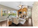 Cozy living room featuring a fireplace, vaulted ceilings and beautiful backyard pool views at 4690 Wrentham Pl, Palm Harbor, FL 34685