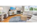 Bright living room features a cozy fireplace, hardwood floors, and stylish furnishings at 623 Garland Cir, Indian Rocks Beach, FL 33785