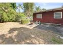 Spacious backyard featuring a concrete patio area, surrounded by mature trees and landscaping at 6427 15Th N St, St Petersburg, FL 33702