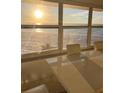 Dining area featuring a modern table with ocean views through a large window, ideal for entertaining at 880 Mandalay Ave # S302, Clearwater Beach, FL 33767