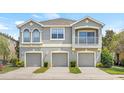Well-maintained townhome with a private balcony and garages at 8848 Moonlit Meadows Loop, Riverview, FL 33578