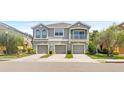 Townhome complex with well-maintained landscaping and garages at 8848 Moonlit Meadows Loop, Riverview, FL 33578