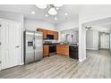 Modern kitchen with stainless steel appliances, wood cabinetry, and an open layout at 9551 Maxson Dr, Land O Lakes, FL 34638