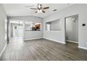 Open concept living area with wood-look flooring, vaulted ceilings, and lots of natural light at 9551 Maxson Dr, Land O Lakes, FL 34638