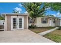 Attractive home with a well-maintained front lawn, featuring a detached garage and convenient walkway to the entrance at 10381 108Th Ave, Largo, FL 33773