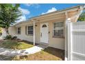 Inviting front entrance showcasing a classic white door with a decorative window and neutral exterior paint at 10381 108Th Ave, Largo, FL 33773