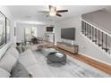 Spacious living room with an open floor plan that flows into dining area, featuring stylish decor and modern finishes at 10436 Rivercrest Dr, Riverview, FL 33578