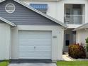 Charming home exterior with a garage, awning, and well-maintained landscaping at 11351 Shipwatch Ln # 1844, Largo, FL 33774