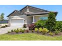 Lovely single-Gathering home with a two-car garage and a meticulously maintained front garden at 11520 Myakka Blue Dr, Venice, FL 34293