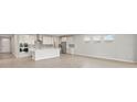 Modern kitchen with stainless steel appliances, island, sleek countertops, and ample cabinet space at 11520 Myakka Blue Dr, Venice, FL 34293