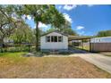 Charming single-story home featuring large windows and a covered carport at 11940 Terra Ceia Ave, New Port Richey, FL 34654