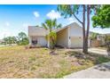 Charming one-story home on a large lot with mature trees, a two-car garage, and a landscaped yard at 12002 Peony Ct, Tampa, FL 33635